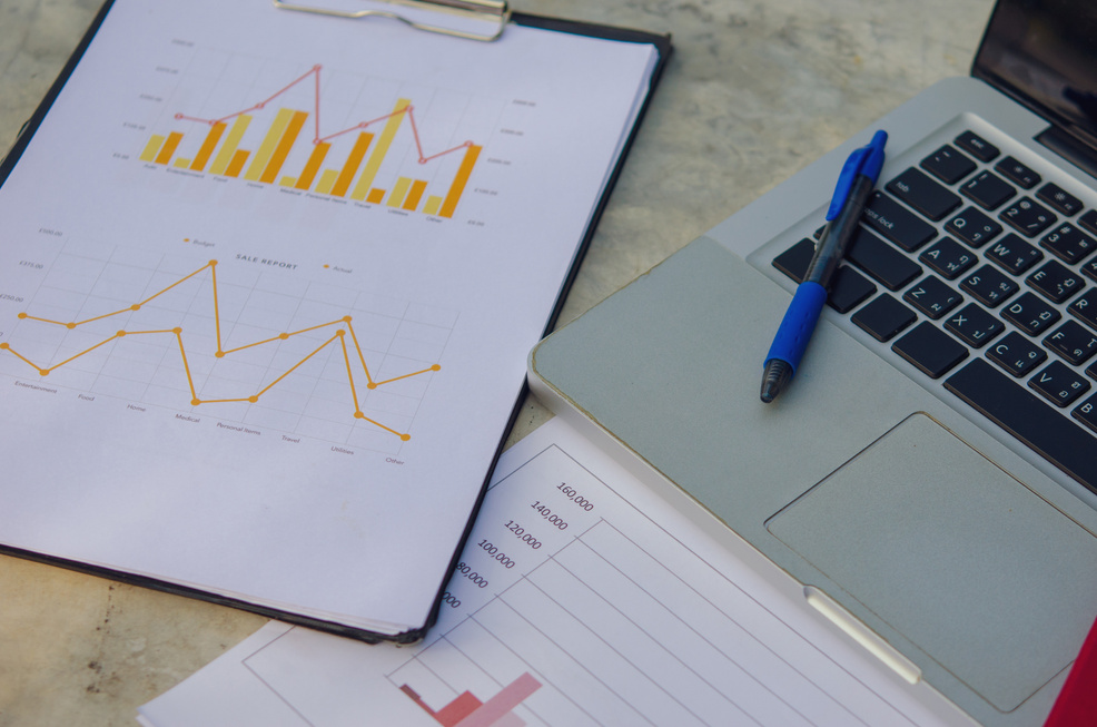 Financial Chart and Laptop on the Office Table 